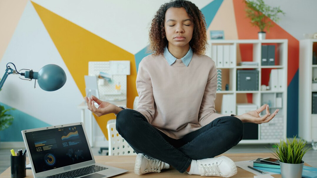 person meditating at desk