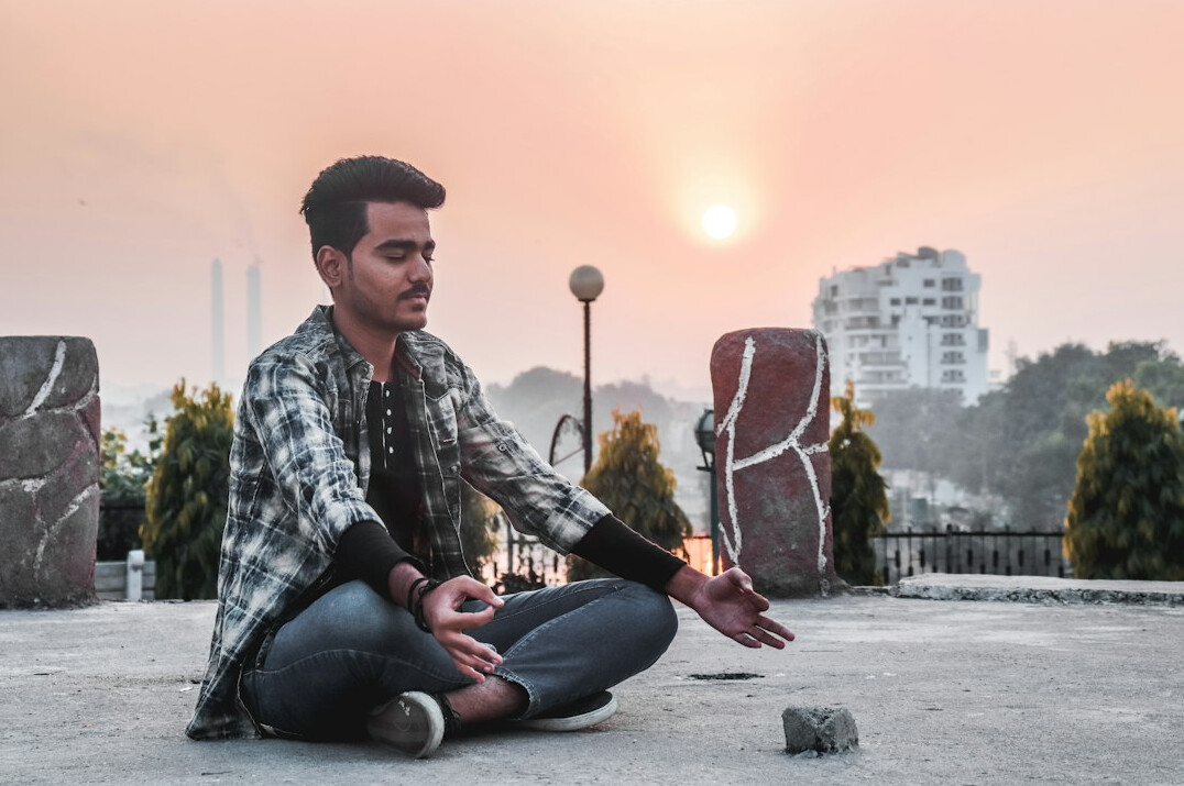 person meditating in morning light
